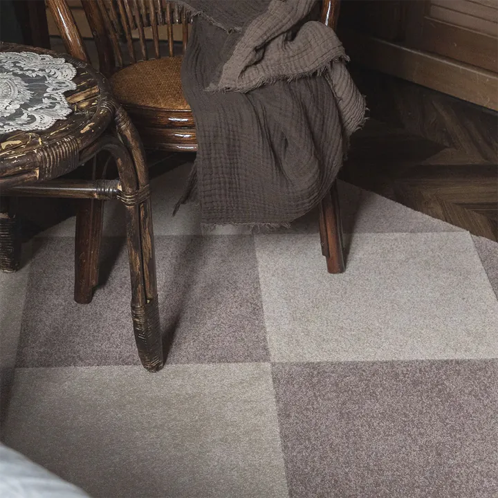 Neutral TOLI modular carpet tiles arranged beneath Japanese-style wood furniture